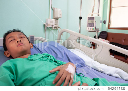 The boy on the patient's bed in the hospital The boy on the patient's bed in the hospital 64294588