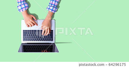 Person using a laptop computer 64296175