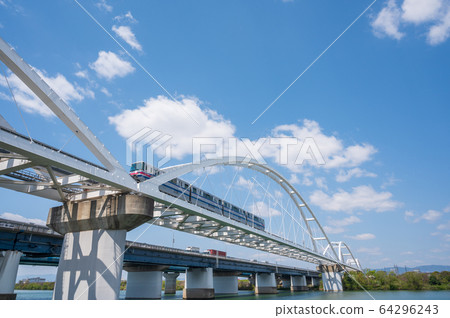 A monorail crossing the iron bridge over the Yodo River 64296243
