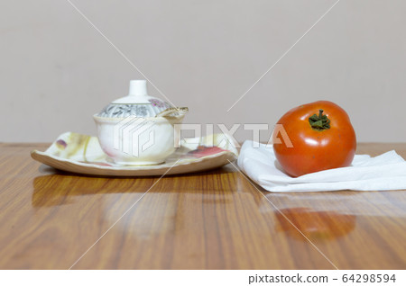 Tomato and Saucers on wooden dining table. Tomato Tomato and Saucers on wooden dining table. Tomato 64298594