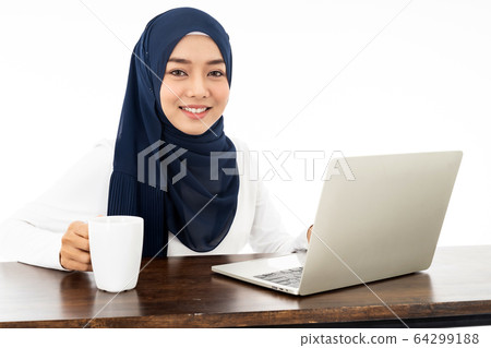 Muslim woman working from home Muslim woman working from home 64299188