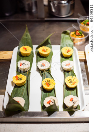 Rice and corn chinese snacks on bamboo leaves 64299511