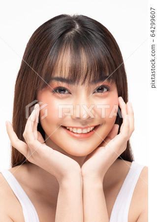 Young Beautiful Asian woman smile touching soft cheek with clean and fresh skin 64299607