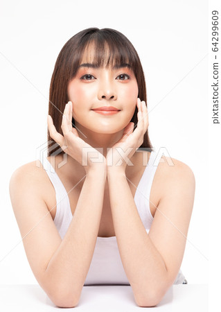 Young Beautiful Asian woman smile touching soft cheek with clean and fresh skin 64299609