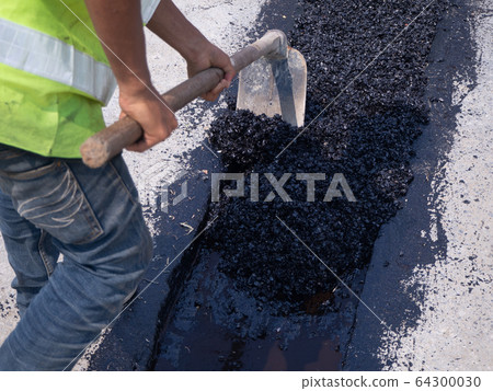 Worker use vibratory plate compactor compacting Worker use vibratory plate compactor compacting 64300030