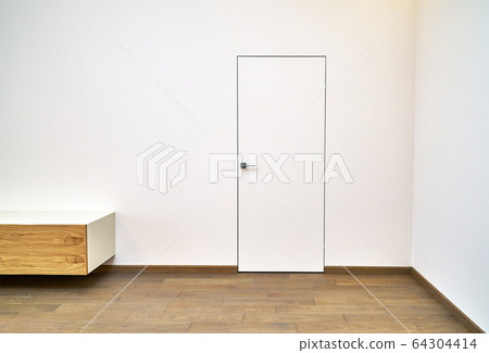 Invisible interior door. Aluminum frame hidden door in modern house 64304414