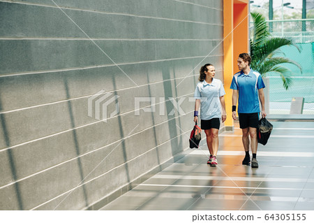 Couple walking home after training 64305155