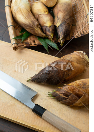 Bamboo shoots on a cutting board 64307814