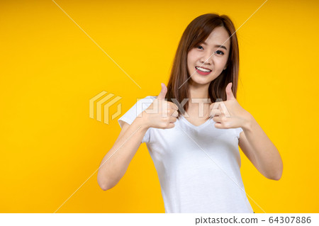 Close up of young Asian woman isolated on yellow Close up of young Asian woman isolated on yellow 64307886