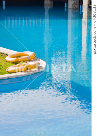Lifebuoys by outdoor pool at luxury hotel. Lifebuoys by outdoor pool at luxury hotel. 64308132
