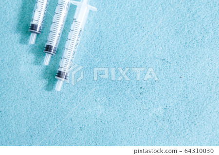 syringe on blue background. three of the medical device. Concept of vaccination, quarantine, self-isolation, protection from coronavirus, virus, fear of disease, treatment, medicine. copy Space 64310030