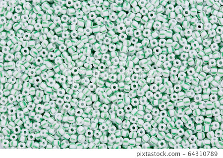 White beads with green lines in texture form. 64310789