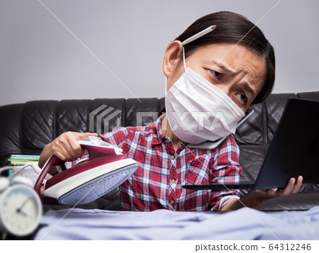 woman working with very busy business and housework part, ironing cloth, talking on phone and working with laptop during self isolation to avoid spreading illness transmission of COVID-19 Coronavirus 64312246