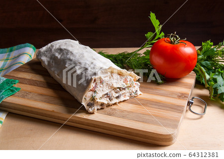 Pita bread or lavash wrapped with cottage cheese 64312381