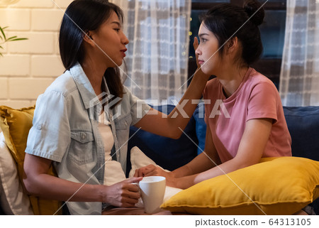 Asian lesbian couple comforting girlfriend when 64313105