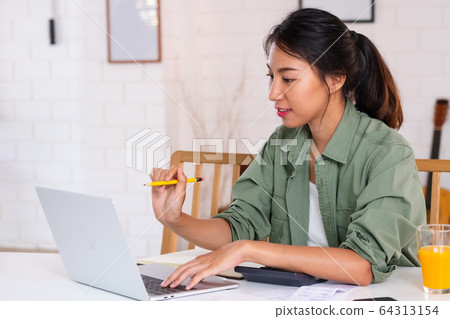 Asian woman use laptop and calculator calculate 64313154