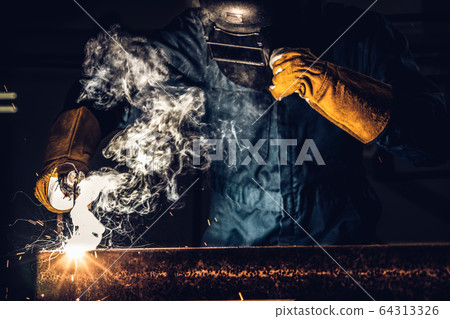 Metal welder working with arc welding machine. Metal welder working with arc welding machine. 64313326