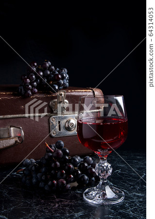 Glass of red wine on dark marble background. 64314053