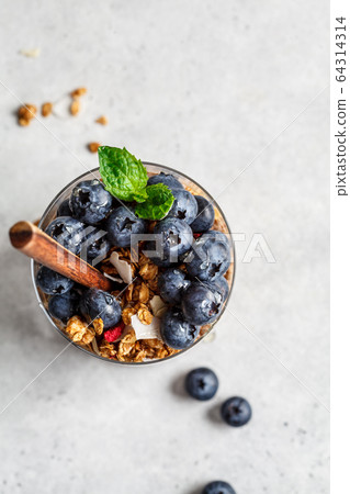 Breakfast in glass with granola and berries 64314314