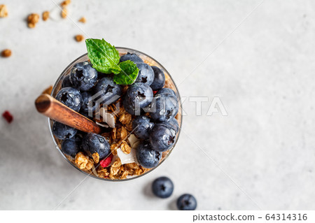 Breakfast in glass with granola and berries, top view Breakfast in glass with granola and berries, top view 64314316
