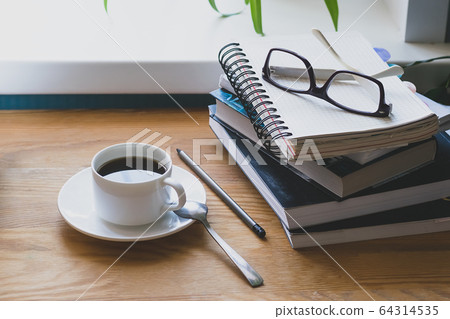 Workplace of a man a desk book in home interior. The concept of distance learning or online learning. 64314535