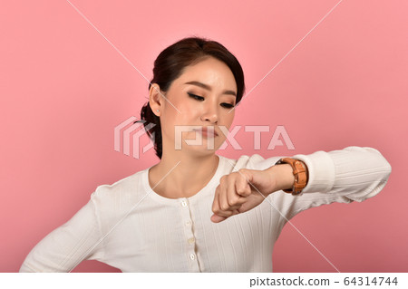Angry and upset asian woman waiting for someone Angry and upset asian woman waiting for someone 64314744