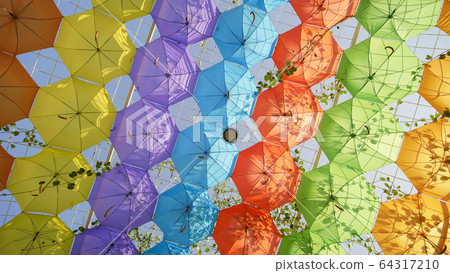 Multi-colored umbrellas in the park of the city. Multi-colored umbrellas in the park of the city. 64317210