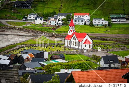 Typical church in Faroe Islands in the middle of the village 64317740