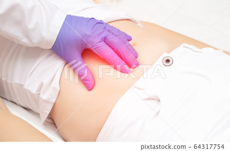 The doctor examines the stomach of the girl patient for the presence of appendicitis. The concept of abdominal pain on the right side, peritonitis, surgery for appendicitis, treatment The doctor examines the stomach of the girl patient for the presence of appendicitis. The concept of abdominal pain on the right side, peritonitis, surgery for appendicitis, treatment 64317754