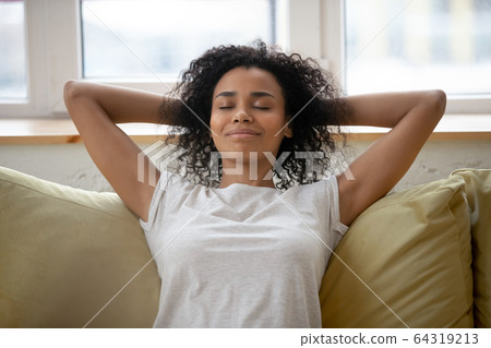 Rest african american woman with hands behind head relaxing. Rest african american woman with hands behind head relaxing. 64319213