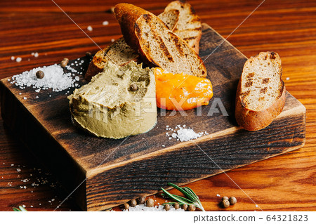 A pate sitting on top of a wooden table A pate sitting on top of a wooden table 64321823