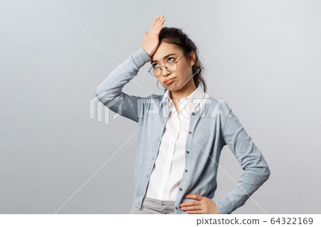 Oh my god, so lame. Tired and annoyed asian woman, teacher having troubles with online education app, punch forehead, facepalm sighing heavily and roll eyes irritated, stand grey background Oh my god, so lame. Tired and annoyed asian woman, teacher having troubles with online education app, punch forehead, facepalm sighing heavily and roll eyes irritated, stand grey background 64322169