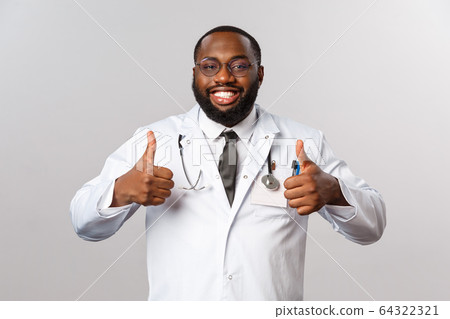 Healthcare, medicine and hospital treatment concept. Happy satisfied african-american bearded doctor in glasses and white coat, show thumb-up relieved, tell patient their test result is fine 64322321