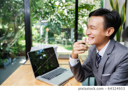 Young businessman laughing with a colleague. 64324933