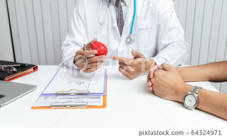 Doctor explaining heart to patient. 64324971