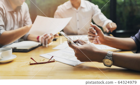 Businessman using smart phone while conference. Businessman using smart phone while conference. 64324979