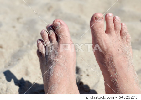 a pair of feet in the sand a pair of feet in the sand 64325275