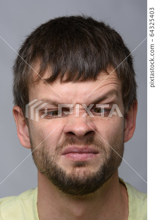 Closeup portrait of a man looking at his nose, 64325403