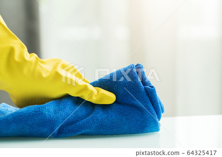 Covid-19 Coronavirus disinfection of home with alcohol, rubber hand glove with micro fiber wipe home Covid-19 Coronavirus disinfection of home with alcohol, rubber hand glove with micro fiber wipe home 64325417