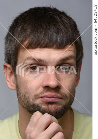 Closeup portrait of a skeptical man of European 64325418