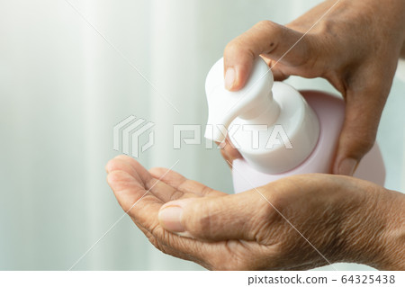 Covid-19 Coronavirus hand cleansing concept, senior hand apply alcohol gel or anti bacteria soap Covid-19 Coronavirus hand cleansing concept, senior hand apply alcohol gel or anti bacteria soap 64325438