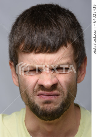Close-up portrait of a man with an emotion of Close-up portrait of a man with an emotion of 64325439