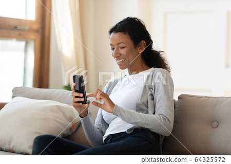 African american smiling woman hold phone in hand 64325572
