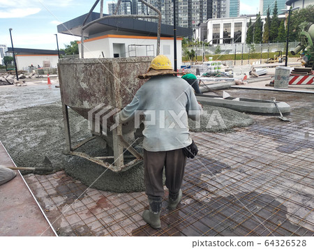 Group of construction workers pouring wet concrete using the mobile crane bucket the construction site.   64326528
