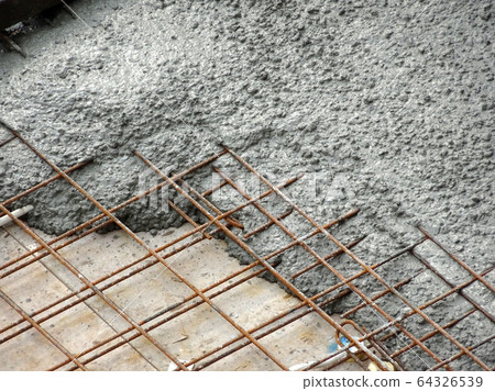 Group of construction workers pouring wet concrete using the mobile crane bucket the construction site.   64326539