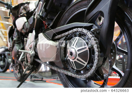 Motorcycle chain. It is a metallic chain that is used to transmit power from the engine to the rear wheel. 64326663