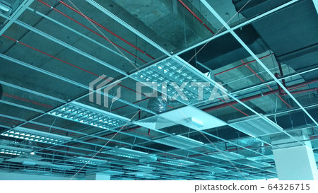 Suspended ceiling frame and board under construction at the construction site. Electrical and mechanical fitting installation work also on going.  64326715