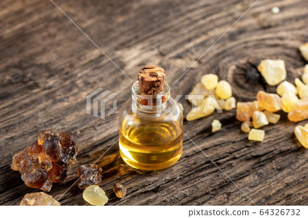 A bottle of frankincense essential oil with frankincense resin A bottle of frankincense essential oil with frankincense resin 64326732