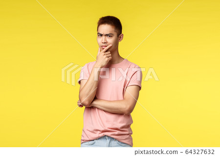 People, different emotions and lifestyle concept. Thoughtful, suspicious asian hipster guy, thinking, touch chin and frowning, squint with disbelief, thinking, being hesitant making choice 64327632