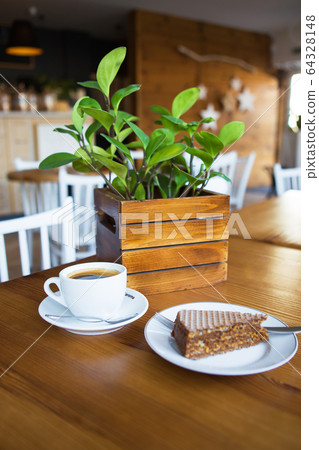 Coffee mug on wooden table, sweet wafer on a Coffee mug on wooden table, sweet wafer on a 64328148